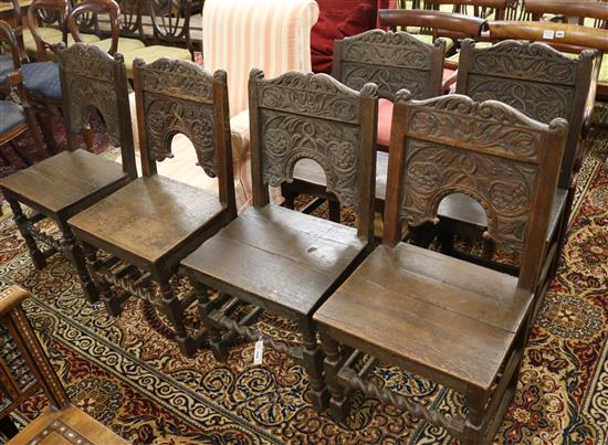 A set of six 17th century style carved oak wood seat chairs